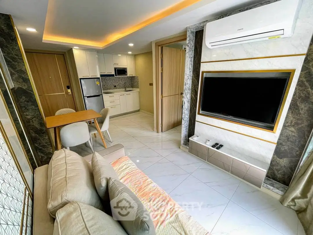 Modern living room with open kitchen, stylish decor, and air conditioning