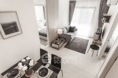 Modern open-plan living room with stylish decor and natural light in a contemporary apartment.