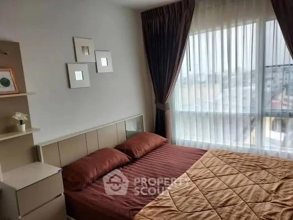 Cozy bedroom with large window and elegant curtains in modern apartment