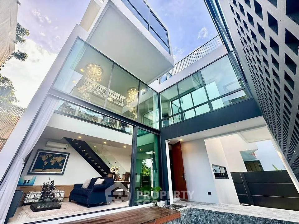 Stunning modern multi-level home with glass facade and spacious open living area.