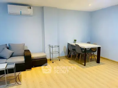 Modern living room with sleek furniture and air conditioning, perfect for comfortable living.
