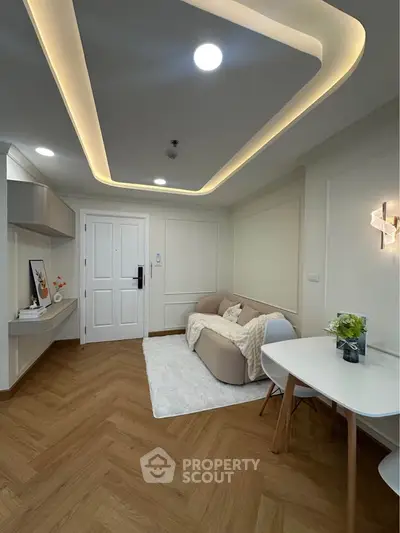 Modern living room with stylish lighting and cozy decor, featuring a chic sofa and elegant dining area.