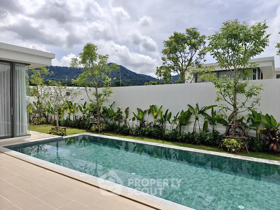 Luxurious private pool with lush garden and mountain view in modern villa