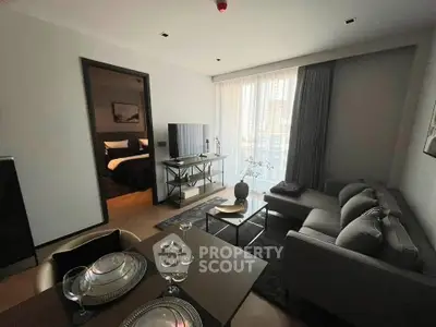 Modern living room with elegant decor and natural light in a stylish apartment.