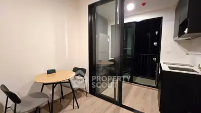 Modern kitchen with open layout and balcony access in stylish apartment