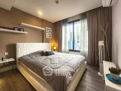 Modern bedroom with stylish decor and large window offering city views.