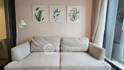 Modern living room with cozy beige sofa and botanical wall art