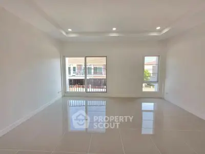Spacious unfurnished room with large windows and glossy tiled floor, perfect for customization.