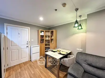 Cozy living room with modern decor and dining area in a stylish apartment.