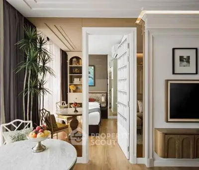 Elegant living room with open layout leading to a cozy bedroom, featuring stylish decor and natural light.