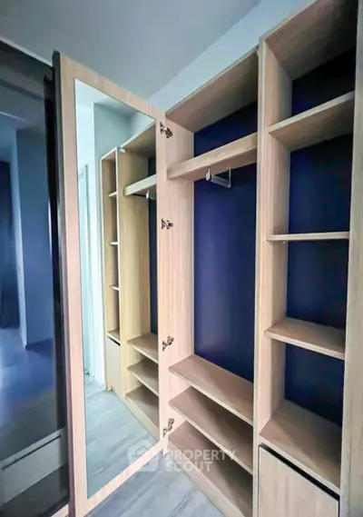 Spacious walk-in closet with modern wooden shelving and mirror door