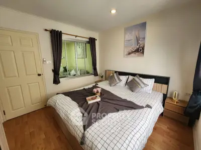 Cozy bedroom with stylish decor and wooden flooring, perfect for relaxation.