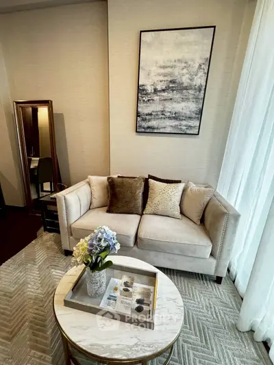 Elegant living room with plush sofa, chic decor, and stylish coffee table.