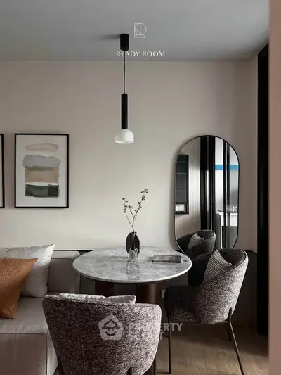 Elegant modern dining area with marble table and stylish chairs in a cozy living space.