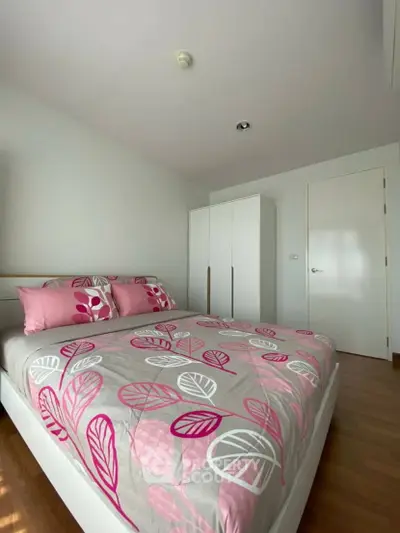 Bright bedroom with modern decor and stylish pink bedding