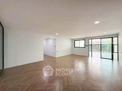 Spacious modern living room with large windows and elegant flooring