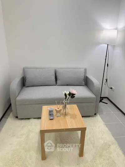 Cozy living room with modern gray sofa and stylish floor lamp