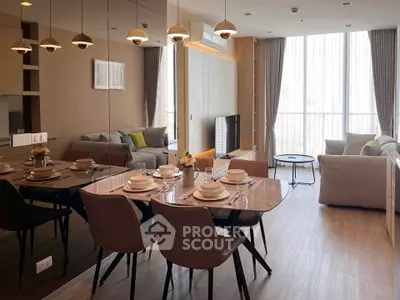 Modern living room with dining area, large windows, and stylish decor in a high-rise apartment.