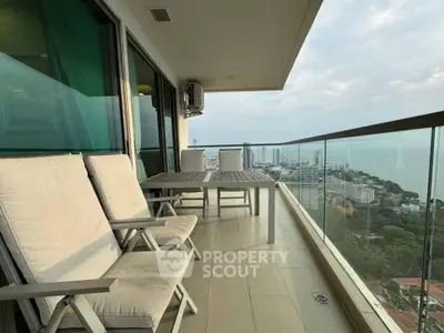 Spacious balcony with stunning ocean view and modern outdoor seating.