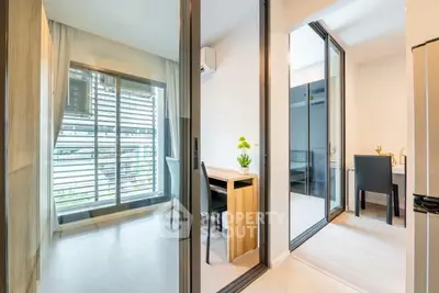 Modern apartment interior with study area and large windows, featuring sleek design and natural light.