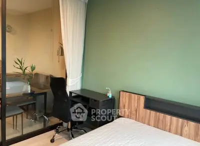Modern bedroom with study area, featuring a sleek desk and comfortable chair.