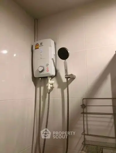 Modern bathroom with electric shower heater and sleek showerhead