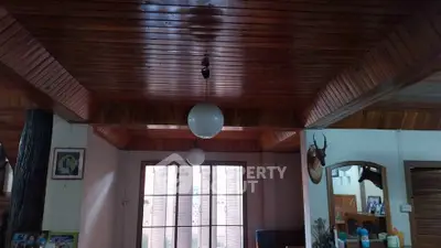Charming wooden ceiling living room with unique lighting and decor