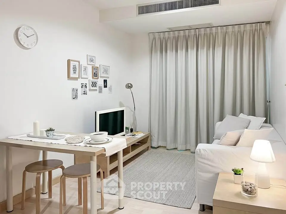 Chic modern living room with cozy decor and natural light, perfect for relaxation and entertainment.
