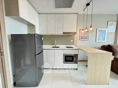 Modern kitchen with sleek cabinetry and integrated appliances in a stylish apartment.