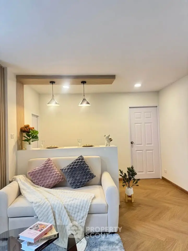 Modern living room with cozy sofa and stylish lighting, perfect for relaxation and entertaining.