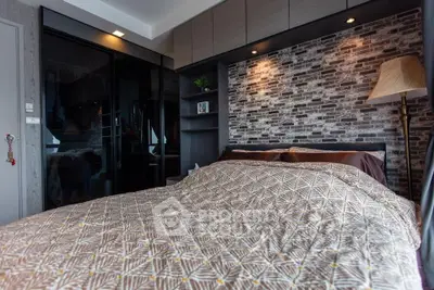 Modern bedroom with stylish brick accent wall and cozy bedding