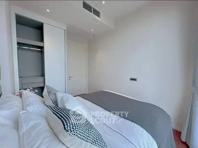 Modern bedroom with sleek design and cozy bedding in a contemporary apartment.