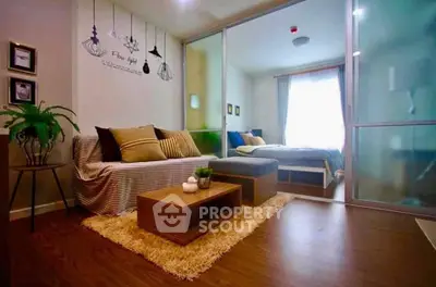 Stylish modern living room with cozy decor and sliding glass doors to bedroom.