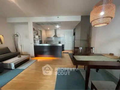 Modern open-plan living and dining area with stylish kitchen and cozy lighting.