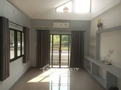 Spacious living room with large windows and balcony access