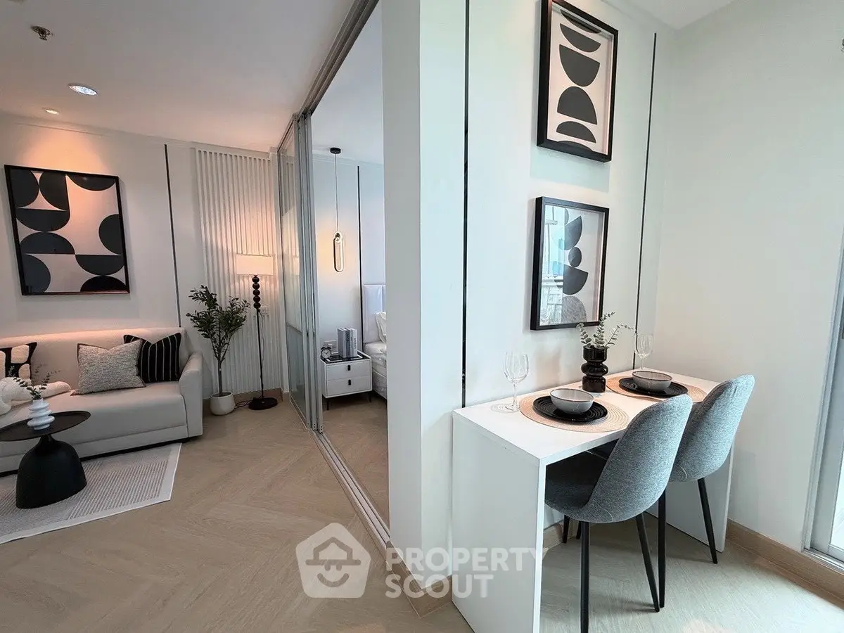 Modern living room with stylish decor and dining area in a contemporary apartment.
