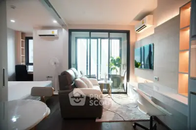 Modern living room with balcony, stylish furniture, and ample natural light in a contemporary apartment.