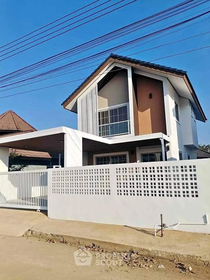 Modern two-story house with stylish facade and spacious balcony