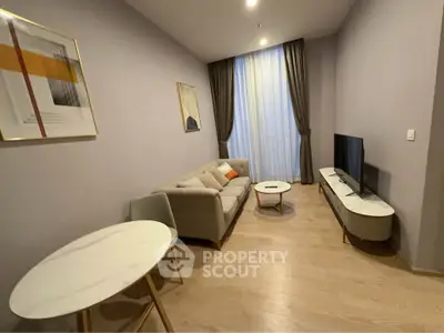 Modern living room with stylish furniture and large window, perfect for cozy evenings.