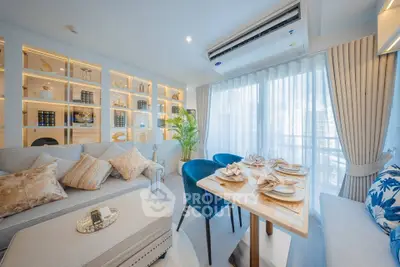 Luxurious living room with elegant decor and dining area, featuring plush seating and ambient lighting.