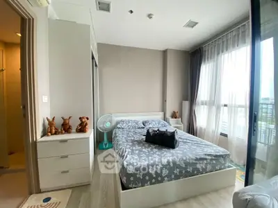 Modern bedroom with large windows and stylish decor in a high-rise apartment.