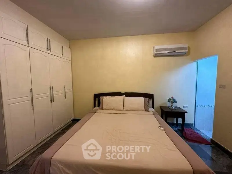 Cozy bedroom with built-in wardrobe and air conditioning, perfect for restful nights.