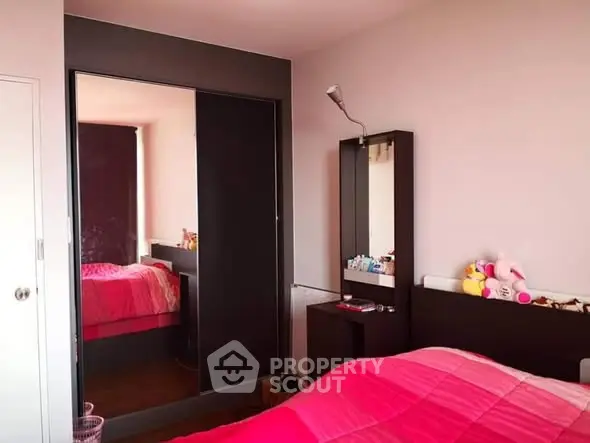 Cozy bedroom with modern furniture and vibrant pink bedding