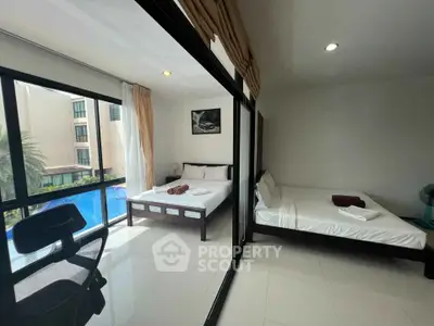 Spacious bedroom with pool view and modern furnishings