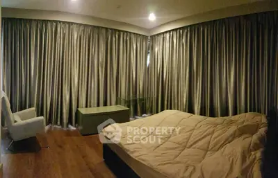 Cozy bedroom with elegant curtains and modern furnishings