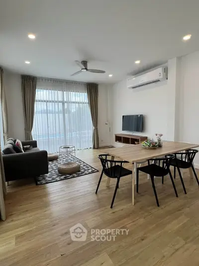 Modern living room with stylish furniture and large windows for natural light.
