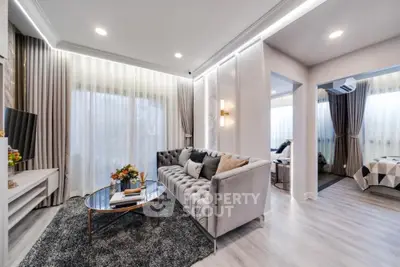 Elegant living room with plush seating, chic decor, and ample natural light, perfect for upscale urban living.