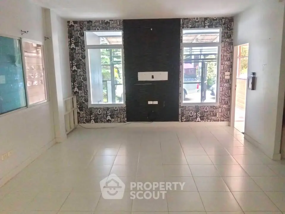 Spacious interior with modern tiled flooring and large windows