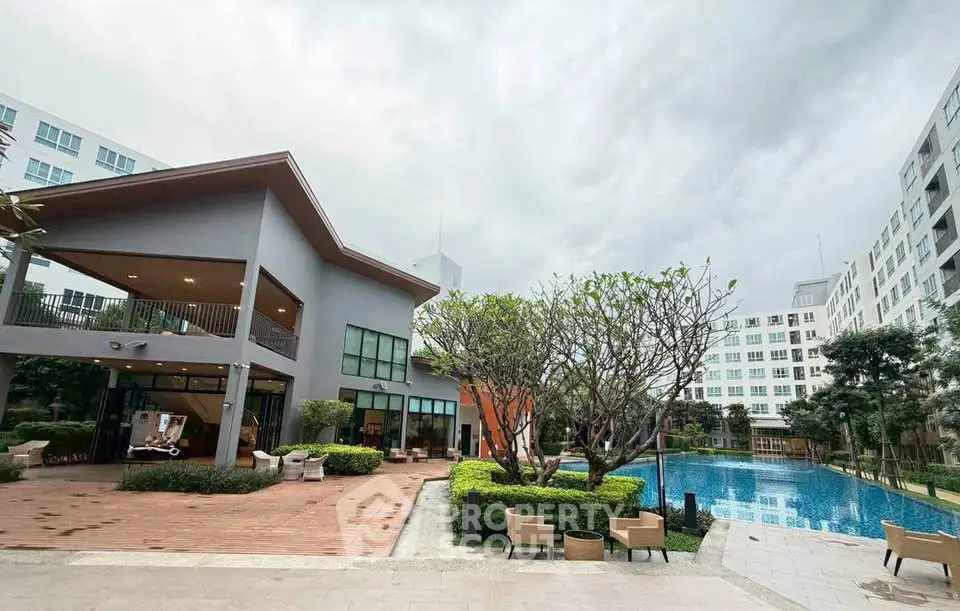 Luxurious apartment complex with modern architecture and inviting swimming pool.