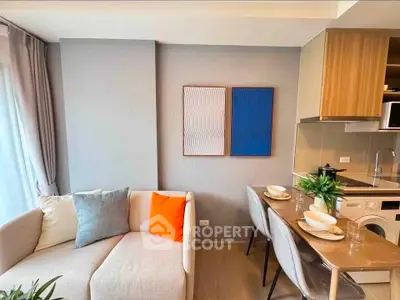 Modern living room with cozy sofa and stylish dining area in open layout apartment.